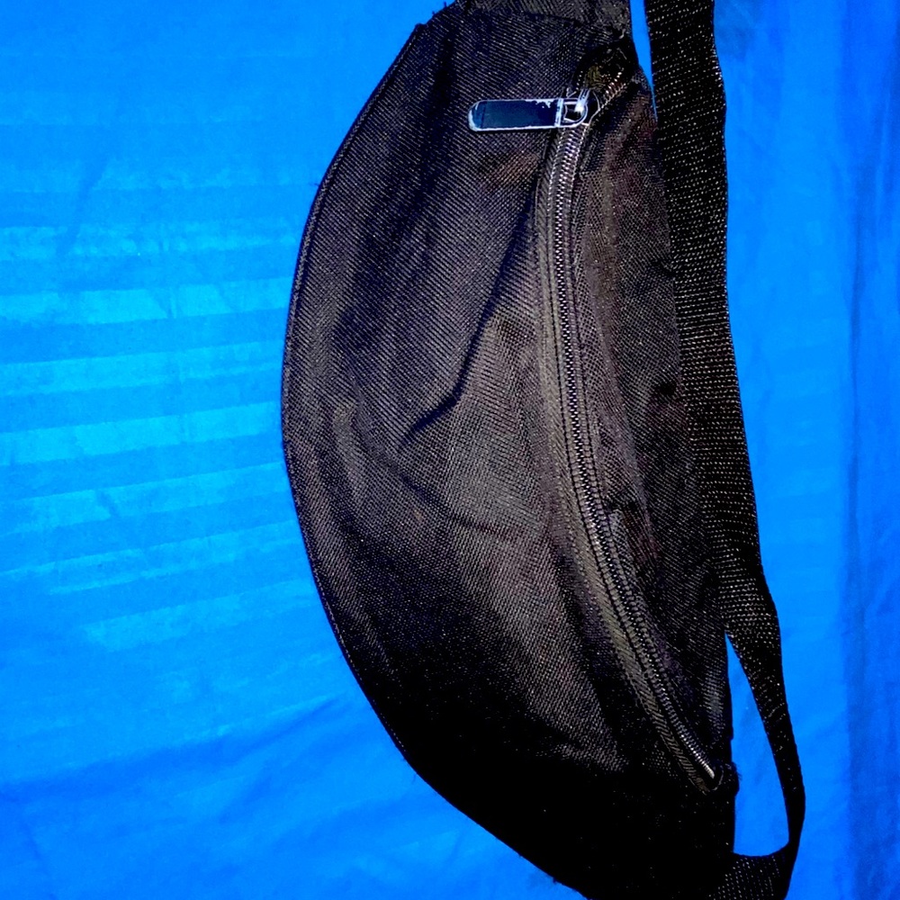 A black Multi-compartment Fanny pack .